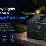 Low voltage transformer installed outdoors at dusk powering a row of garden path lights